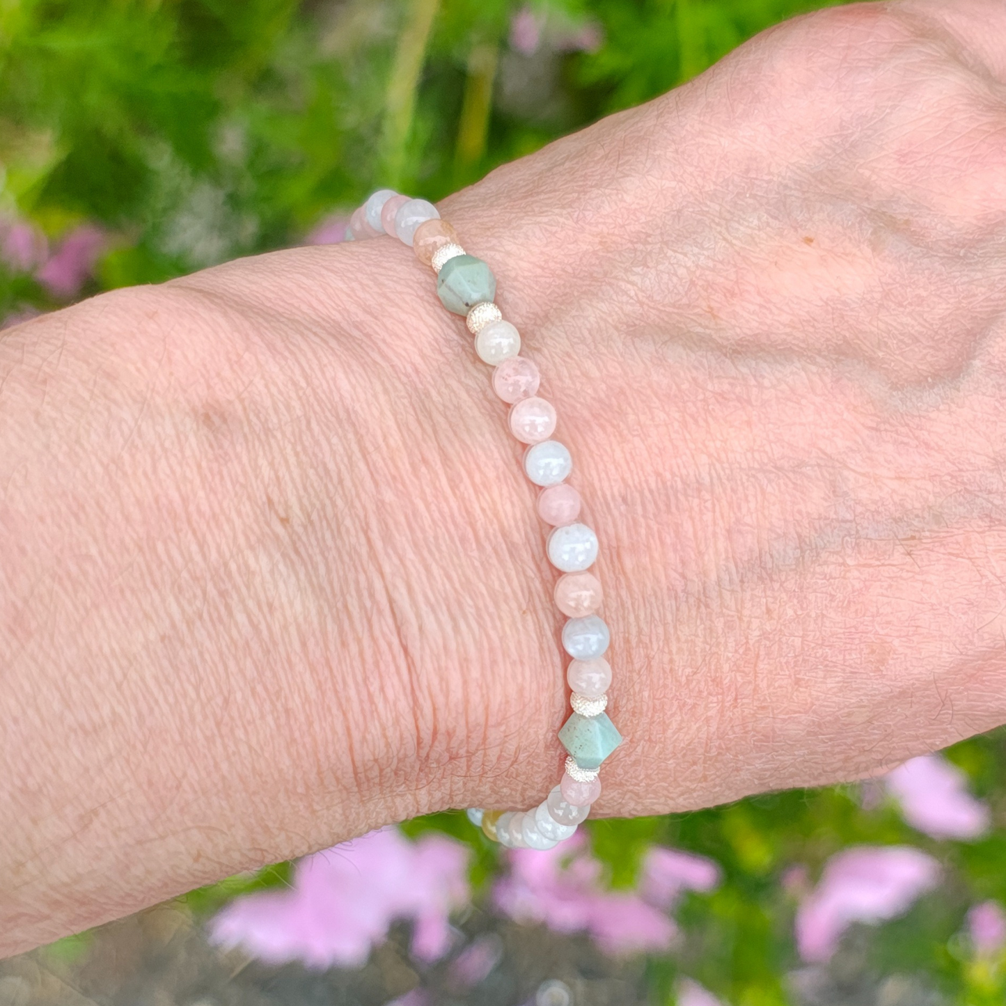 Beaded bracelet on a wrist with a blurred natural background