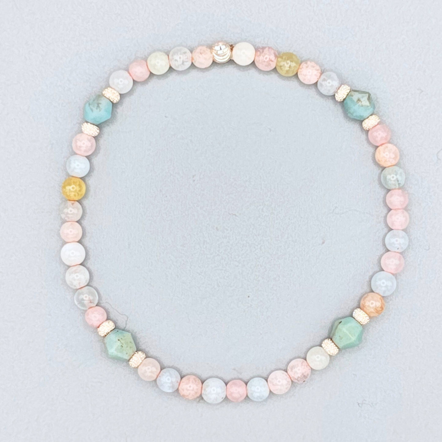 Pastel beaded necklace on a light gray background
